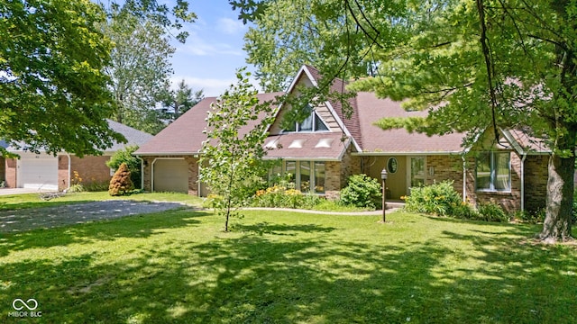 396 W 500 S, Anderson, IN 46013 - tudor-style house featuring a garage, a front yard, and driveway