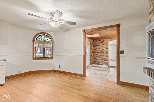 396 W 500 S, Anderson, IN 46013 - spare room featuring light wood finished floors, a ceiling fan, a textured ceiling, and wainscoting