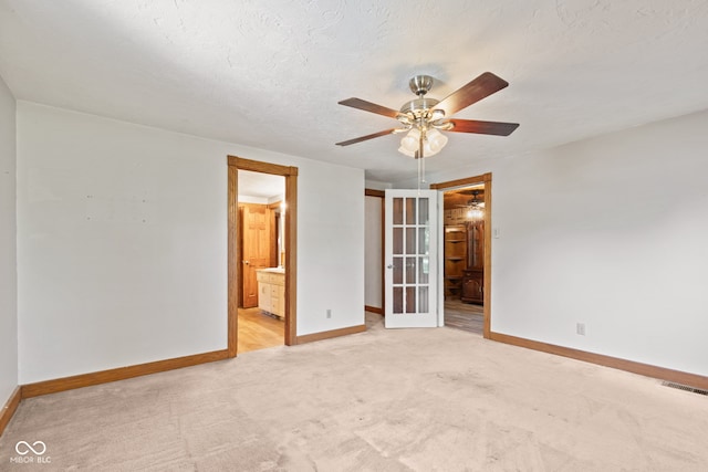 396 W 500 S, Anderson, IN 46013 - unfurnished bedroom featuring connected bathroom, light carpet, and a ceiling fan