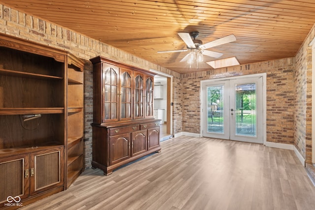 396 W 500 S, Anderson, IN 46013 - unfurnished living room featuring wooden ceiling, brick wall, a ceiling fan, french doors, and light wood-style floors