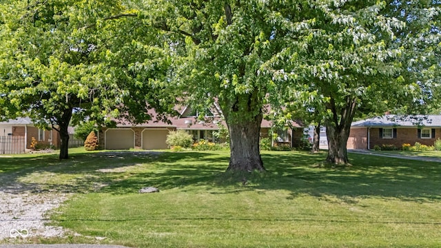 396 W 500 S, Anderson, IN 46013 - view of green lawn featuring a garage and driveway