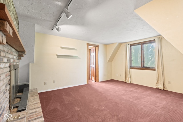 396 W 500 S, Anderson, IN 46013 - unfurnished living room with a fireplace, a textured ceiling, track lighting, and carpet floors
