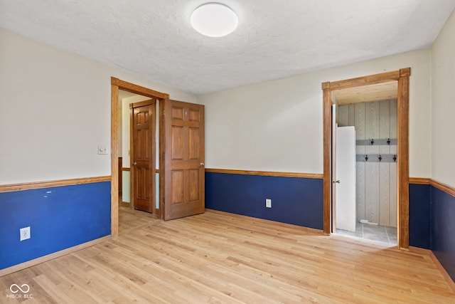 396 W 500 S, Anderson, IN 46013 - spare room featuring wood finished floors, wainscoting, and a textured ceiling
