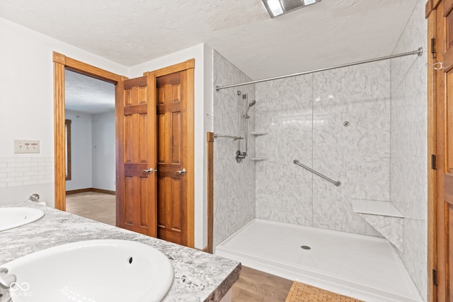 396 W 500 S, Anderson, IN 46013 - bathroom featuring double vanity, a walk in shower, and a textured ceiling
