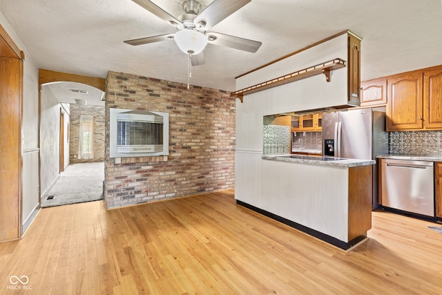 396 W 500 S, Anderson, IN 46013 - kitchen featuring stainless steel appliances, light wood-style flooring, brown cabinets, a peninsula, and a ceiling fan