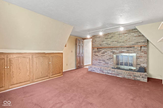 396 W 500 S, Anderson, IN 46013 - unfurnished living room featuring a brick fireplace, light carpet, rail lighting, and a textured ceiling