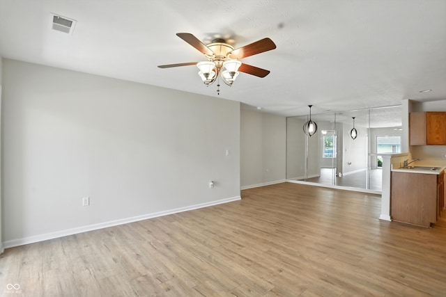5003 Opal Ridge Ln Unit 101, Indianapolis, IN 46237 - unfurnished living room with light wood-type flooring and a ceiling fan