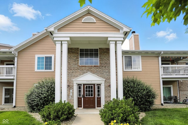 5003 Opal Ridge Ln Unit 101, Indianapolis, IN 46237 - view of front of house featuring a chimney and brick siding