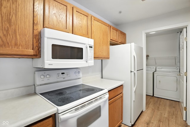 5003 Opal Ridge Ln Unit 101, Indianapolis, IN 46237 - kitchen featuring white appliances, washer and clothes dryer, light countertops, and light wood-style floors