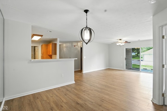 5003 Opal Ridge Ln Unit 101, Indianapolis, IN 46237 - unfurnished living room with light wood finished floors and a ceiling fan