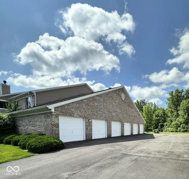 5003 Opal Ridge Ln Unit 101, Indianapolis, IN 46237 - view of side of home with brick siding and community garages