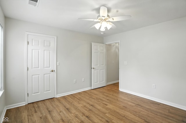 5003 Opal Ridge Ln Unit 101, Indianapolis, IN 46237 - unfurnished bedroom with wood finished floors and a ceiling fan