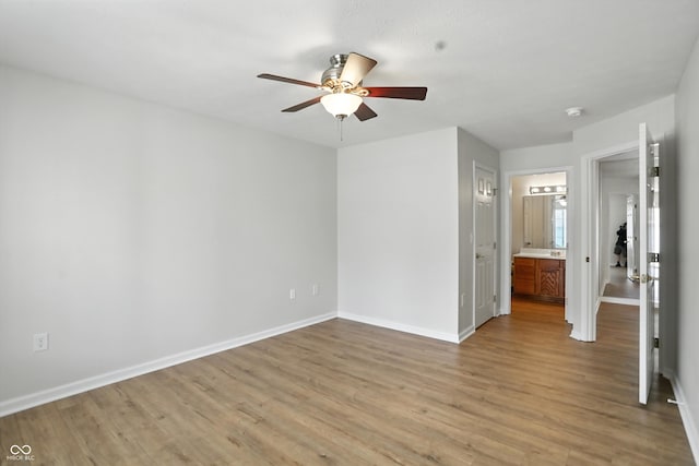 5003 Opal Ridge Ln Unit 101, Indianapolis, IN 46237 - unfurnished bedroom featuring light wood-style floors, connected bathroom, and a ceiling fan