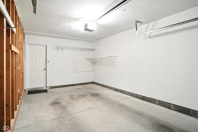 5003 Opal Ridge Ln Unit 101, Indianapolis, IN 46237 - garage with a garage door opener and baseboards