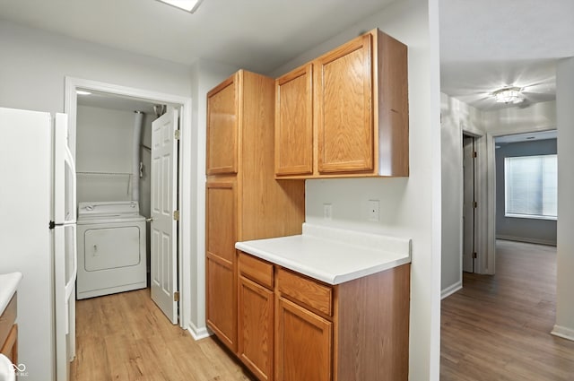 5003 Opal Ridge Ln Unit 101, Indianapolis, IN 46237 - kitchen featuring washer / dryer, light wood-type flooring, light countertops, and freestanding refrigerator