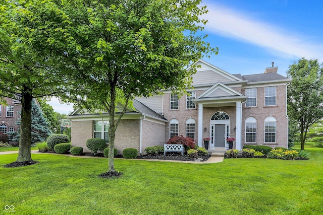 3345 Kilkenny Cir, Carmel, IN 46032 - neoclassical home with a front yard, brick siding, and a chimney