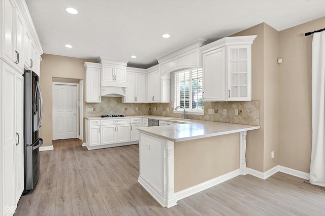 3345 Kilkenny Cir, Carmel, IN 46032 - kitchen with a peninsula, light wood-type flooring, freestanding refrigerator, white cabinetry, and light countertops
