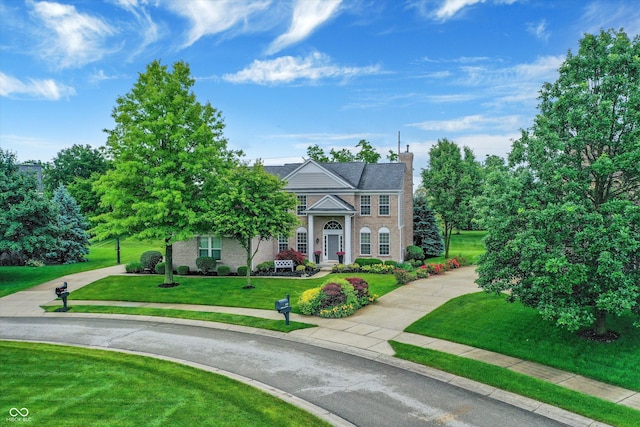 3345 Kilkenny Cir, Carmel, IN 46032 - view of front of home featuring a front yard, a chimney, and brick siding