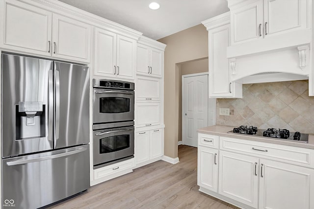 3345 Kilkenny Cir, Carmel, IN 46032 - kitchen featuring stainless steel appliances, light countertops, tasteful backsplash, light wood-style flooring, and white cabinets