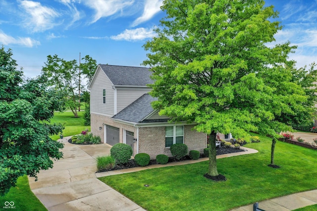 3345 Kilkenny Cir, Carmel, IN 46032 - view of front facade featuring a garage, concrete driveway, a front yard, brick siding, and roof with shingles
