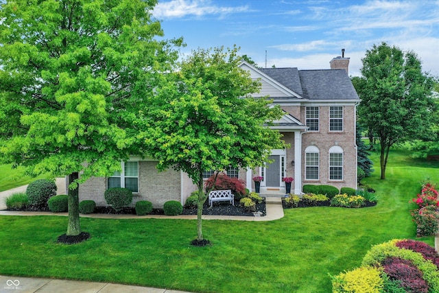3345 Kilkenny Cir, Carmel, IN 46032 - view of front facade with a chimney, a front yard, and brick siding