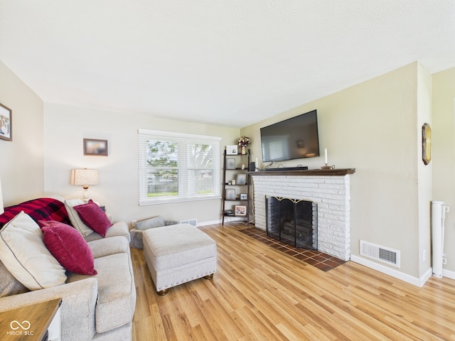 3809 N Glenwood Ave, Muncie, IN 47304 - living area with light wood-type flooring and a brick fireplace