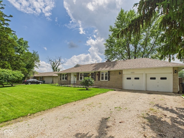 3809 N Glenwood Ave, Muncie, IN 47304 - single story home with a garage, dirt driveway, a front lawn, and stone siding