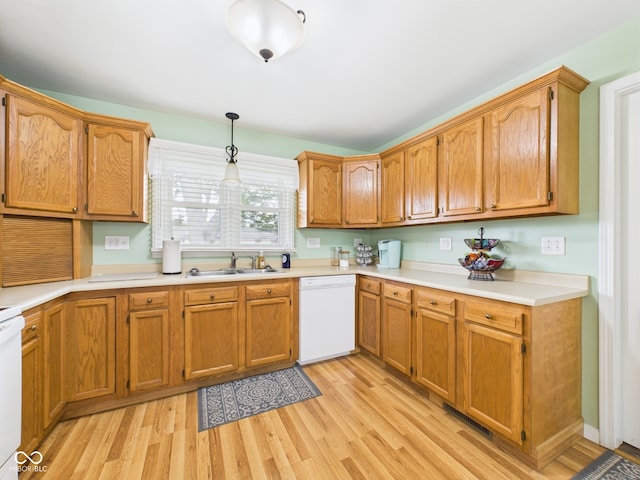 3809 N Glenwood Ave, Muncie, IN 47304 - kitchen with dishwasher, light wood-style floors, light countertops, hanging light fixtures, and brown cabinets
