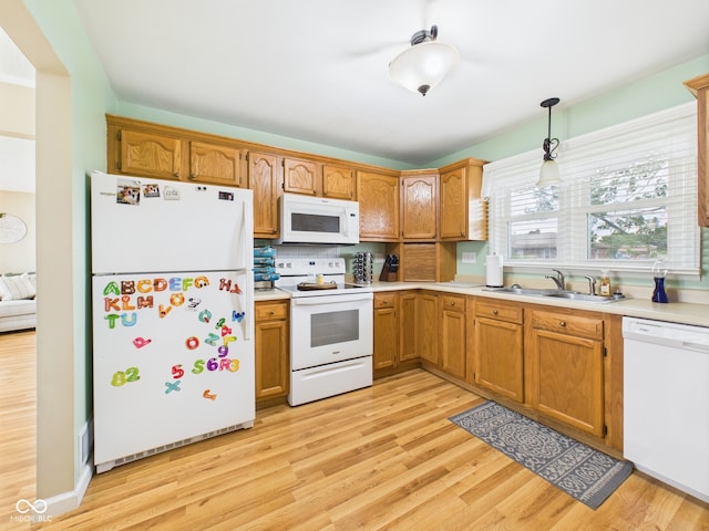 3809 N Glenwood Ave, Muncie, IN 47304 - kitchen with white appliances, light countertops, light wood-style floors, and brown cabinets