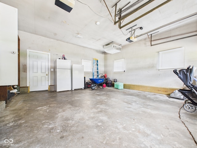 3809 N Glenwood Ave, Muncie, IN 47304 - garage with freestanding refrigerator and a garage door opener