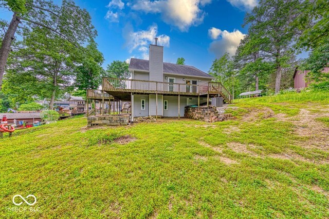 8635 S Providence Dr, Nineveh, IN 46164 - back of property with a wooden deck, a chimney, a yard, and stairs