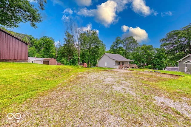 8635 S Providence Dr, Nineveh, IN 46164 - view of green lawn with an outbuilding, a wooden deck, and view of wooded area