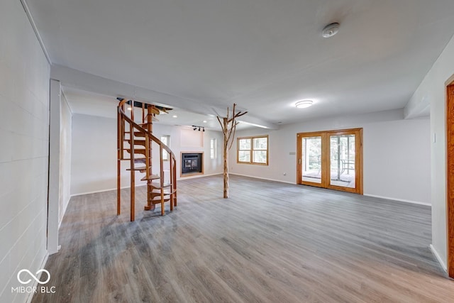 8635 S Providence Dr, Nineveh, IN 46164 - unfurnished living room with wood finished floors and a glass covered fireplace