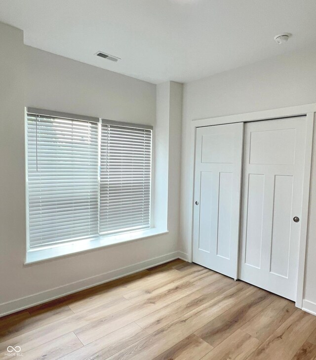 4726 Deacon Ln, Indianapolis, IN 46237 - unfurnished bedroom with light wood-style floors and a closet
