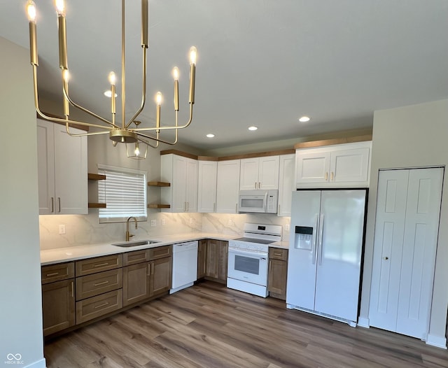 4726 Deacon Ln, Indianapolis, IN 46237 - kitchen with white appliances, open shelves, wood finished floors, a chandelier, and backsplash