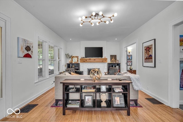 4046 N Park Ave, Indianapolis, IN 46205 - living area with light wood-type flooring, a chandelier, and a fireplace