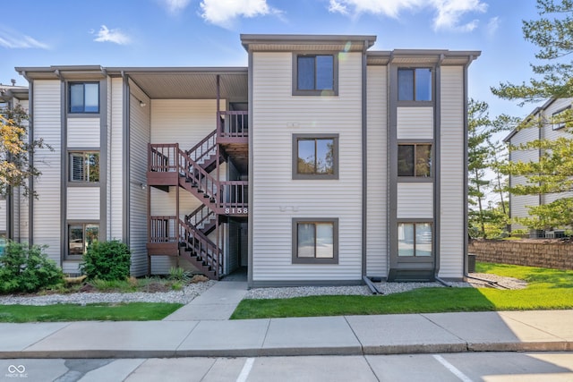 8158 Shorewalk Dr Unit F, Indianapolis, IN 46236 - view of property with stairway and uncovered parking