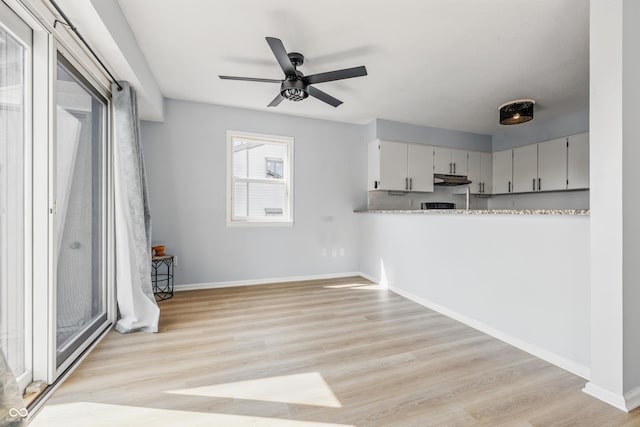 8158 Shorewalk Dr Unit F, Indianapolis, IN 46236 - kitchen featuring ceiling fan, under cabinet range hood, light wood-style floors, and light countertops