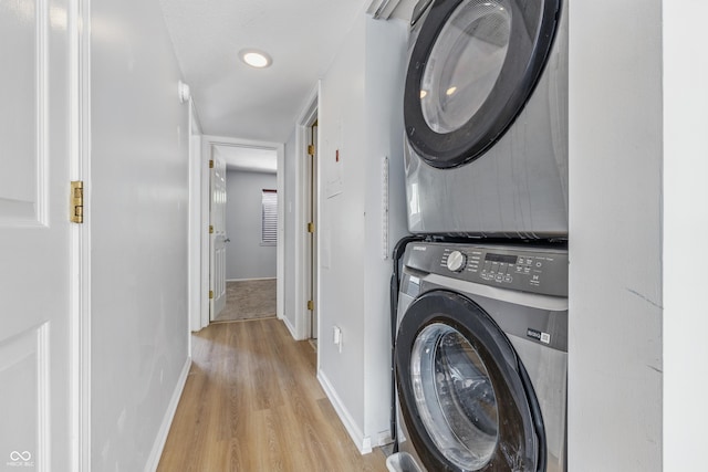 8158 Shorewalk Dr Unit F, Indianapolis, IN 46236 - laundry area with stacked washer and clothes dryer and light wood-style flooring