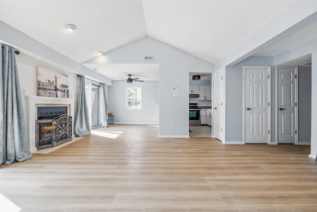 8158 Shorewalk Dr Unit F, Indianapolis, IN 46236 - unfurnished living room featuring a ceiling fan, a fireplace with flush hearth, lofted ceiling, and light wood finished floors