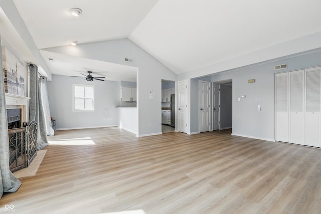 8158 Shorewalk Dr Unit F, Indianapolis, IN 46236 - unfurnished living room with a ceiling fan, vaulted ceiling, a fireplace, and light wood-type flooring