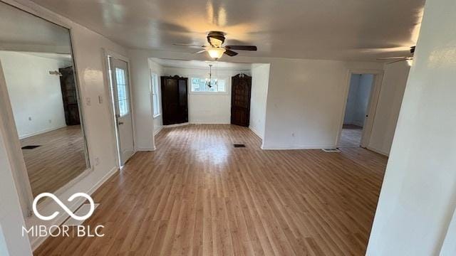 252 Ringwood Way, Anderson, IN 46013 - unfurnished room with a ceiling fan, light wood-style floors, and a chandelier