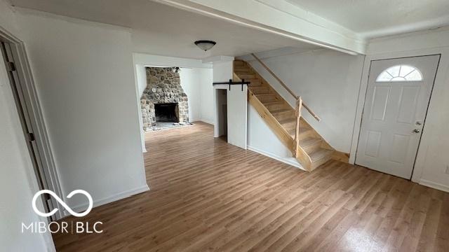 252 Ringwood Way, Anderson, IN 46013 - entryway with stairway, wood finished floors, and a stone fireplace