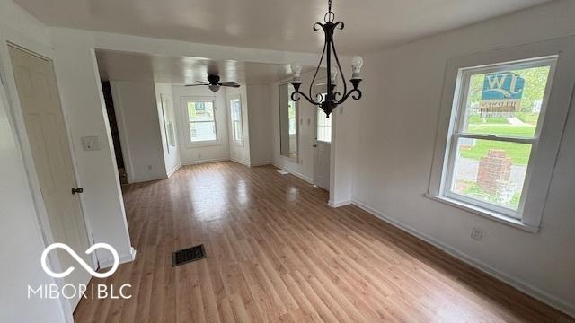 252 Ringwood Way, Anderson, IN 46013 - unfurnished dining area featuring light wood-style floors and a chandelier