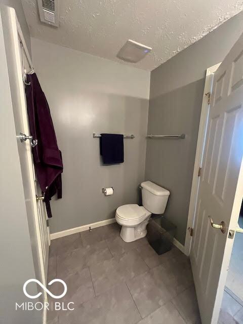 2231 Abbey St, Brownsburg, IN 46112 - bathroom with a textured ceiling and tile patterned flooring