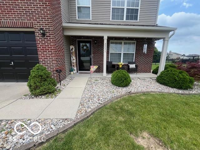 2231 Abbey St, Brownsburg, IN 46112 - doorway to property featuring a porch and brick siding