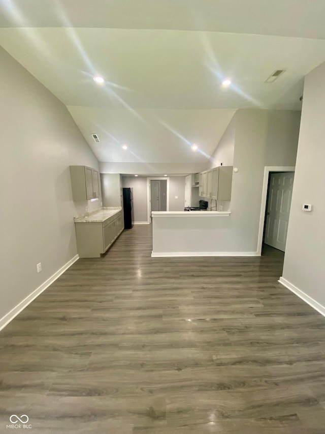 3464 N Bancroft St, Indianapolis, IN 46218 - unfurnished living room featuring vaulted ceiling, dark wood finished floors, and recessed lighting