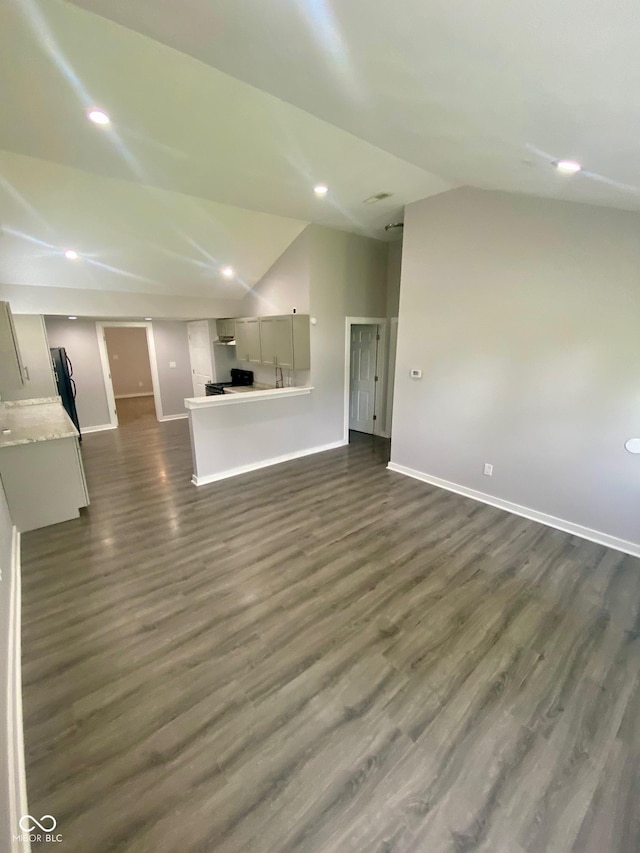 3464 N Bancroft St, Indianapolis, IN 46218 - unfurnished living room with vaulted ceiling, dark wood-style floors, and recessed lighting