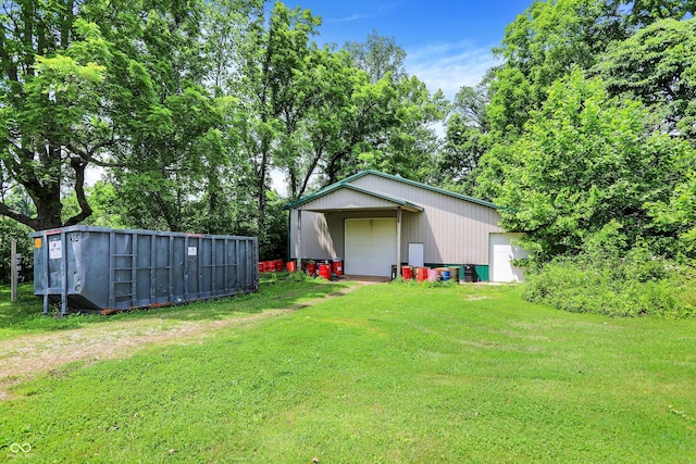 1155 Cope Rd, Martinsville, IN 46151 - view of grassy yard featuring a garage, an outdoor structure, driveway, and view of scattered trees