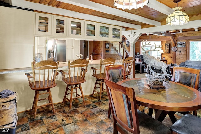 1155 Cope Rd, Martinsville, IN 46151 - dining space featuring a wood ceiling with exposed beams, dark stone finish flooring, and wooden walls